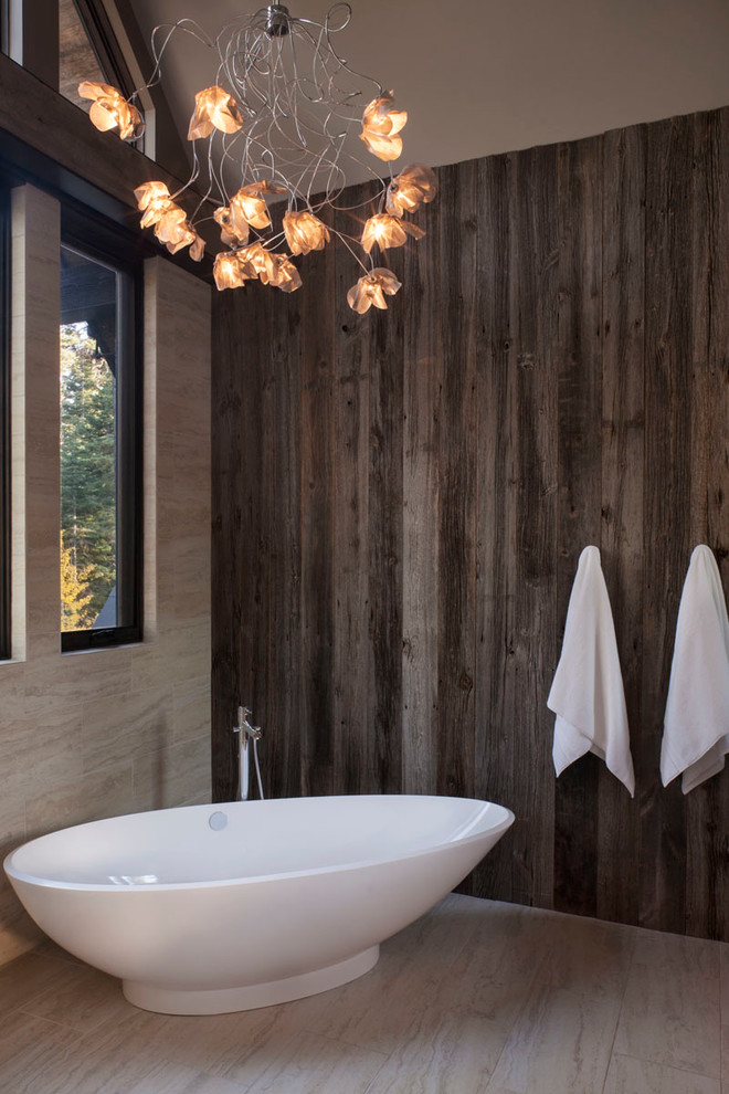 Freestanding bathtub - rustic beige tile freestanding bathtub idea in San Francisco with beige walls