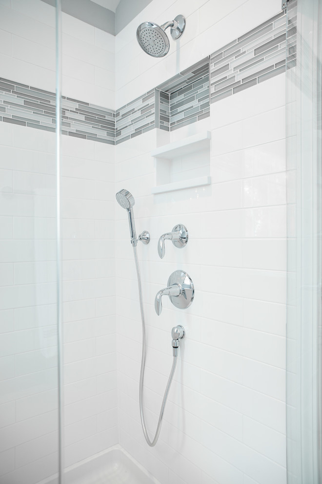 Large traditional ensuite bathroom in Chicago with shaker cabinets, dark wood cabinets, a freestanding bath, a corner shower, a two-piece toilet, white tiles, metro tiles, grey walls, porcelain flooring, a submerged sink, engineered stone worktops, grey floors, a hinged door and white worktops.