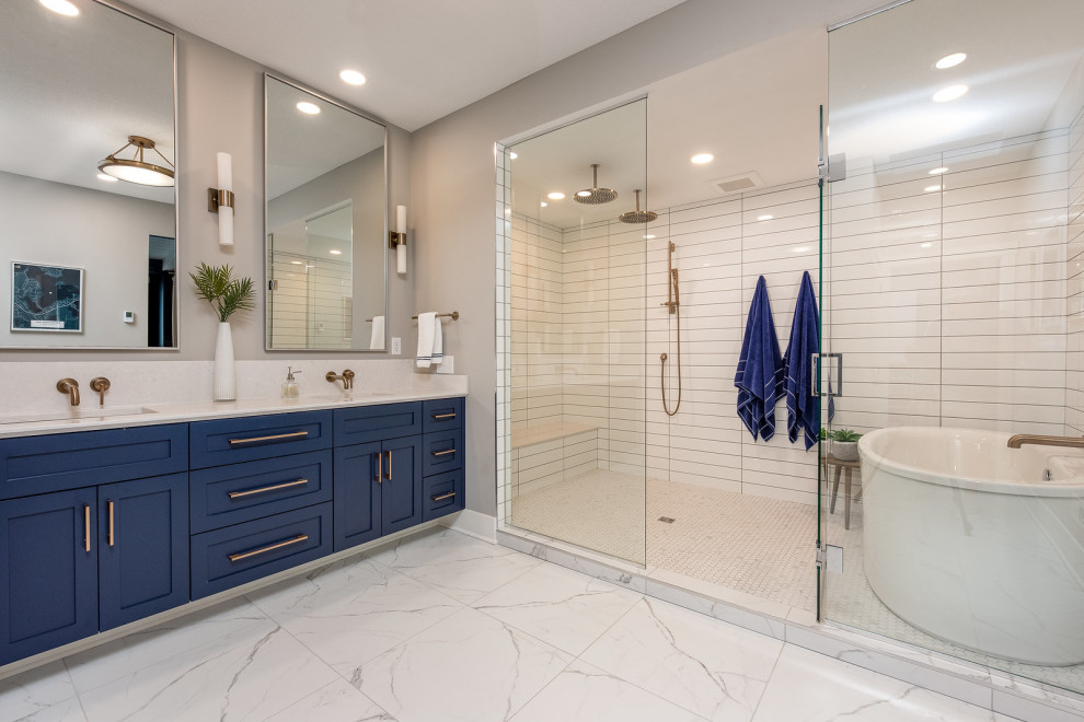 Inspiration for a large coastal master white tile and subway tile porcelain tile, white floor, double-sink and wallpaper bathroom remodel in Minneapolis with shaker cabinets, black cabinets, a two-piece toilet, gray walls, a drop-in sink, quartz countertops, gray countertops and a built-in vanity