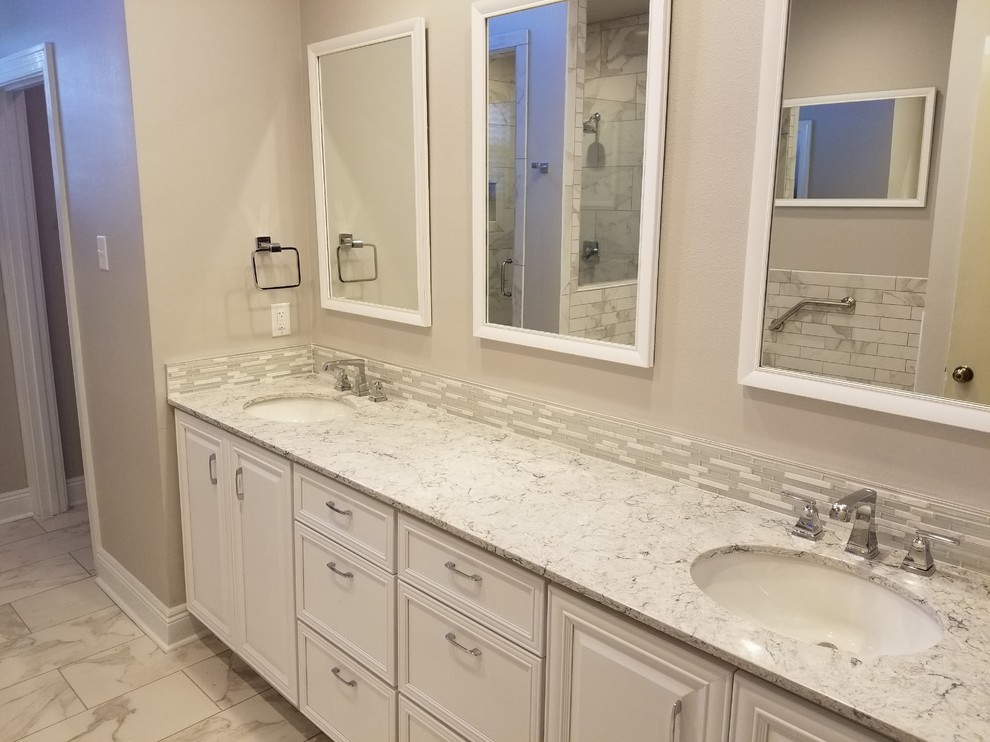 Photo of a medium sized traditional ensuite bathroom in New Orleans with recessed-panel cabinets, white cabinets, a built-in bath, an alcove shower, a two-piece toilet, grey tiles, white tiles, porcelain tiles, grey walls, porcelain flooring, a submerged sink, engineered stone worktops, white floors and a hinged door.