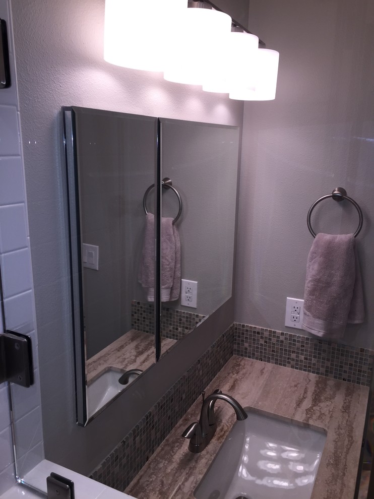 Mid-sized transitional master white tile and porcelain tile ceramic tile corner shower photo in Dallas with an undermount sink, gray cabinets, a two-piece toilet, gray walls, recessed-panel cabinets and marble countertops