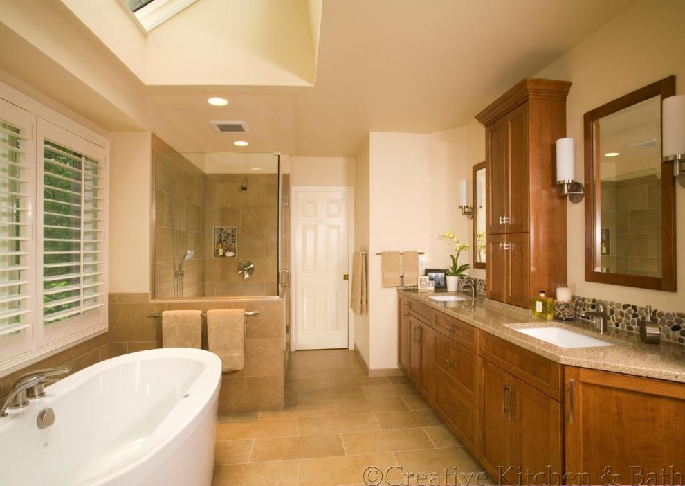 Inspiration pour une salle de bain principale traditionnelle en bois brun de taille moyenne avec un placard à porte shaker, une baignoire indépendante, une douche d'angle, une plaque de galets, un mur beige, un sol en carrelage de céramique, un lavabo encastré et un plan de toilette en granite.