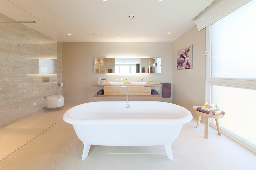Photo of a large contemporary ensuite bathroom in Surrey with a freestanding bath, porcelain flooring and a walk-in shower.