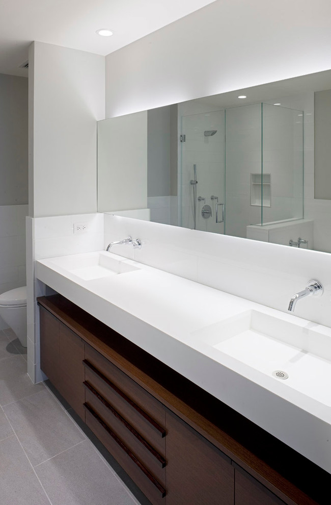 Bathroom - large contemporary master white tile and porcelain tile porcelain tile bathroom idea in Chicago with an integrated sink, flat-panel cabinets, dark wood cabinets, solid surface countertops, a one-piece toilet and gray walls