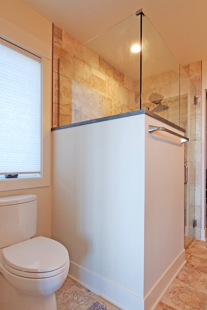 This is an example of a contemporary ensuite bathroom in Grand Rapids with shaker cabinets, a built-in shower, a one-piece toilet, mosaic tile flooring, a submerged sink, a hinged door, a shower bench, double sinks and a built in vanity unit.