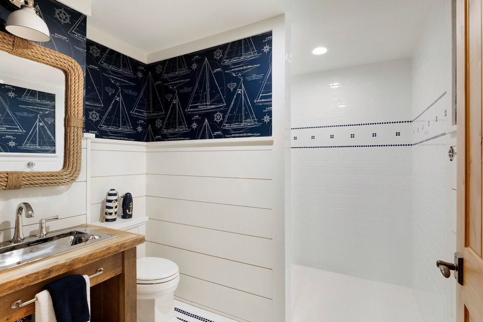 ミネアポリスにある高級な広いビーチスタイルのおしゃれな浴室 (バリアフリー、サブウェイタイル、青い壁、木製洗面台、洗面台1つ、独立型洗面台、塗装板張りの壁) の写真