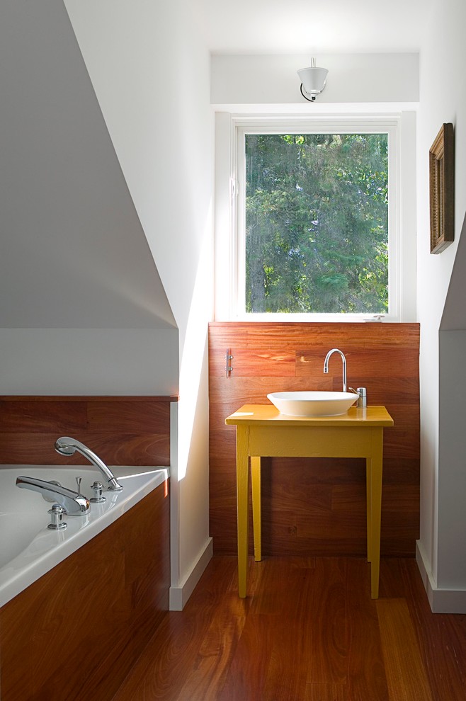 Стильный дизайн: маленькая ванная комната в современном стиле с настольной раковиной, желтыми фасадами, столешницей из дерева, накладной ванной, унитазом-моноблоком, белыми стенами, темным паркетным полом, душевой кабиной, коричневым полом и желтой столешницей для на участке и в саду - последний тренд