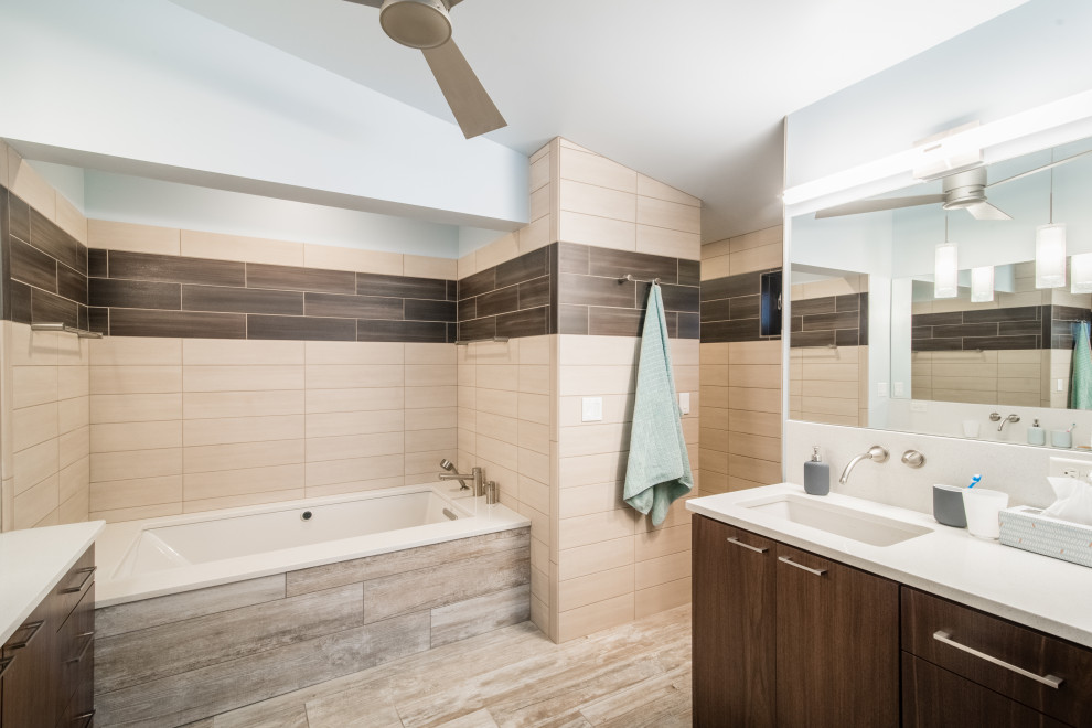 Large rustic ensuite bathroom in Denver with flat-panel cabinets, medium wood cabinets, a built-in bath, a one-piece toilet, brown tiles, porcelain tiles, blue walls, porcelain flooring, a submerged sink, engineered stone worktops, beige floors, an open shower, white worktops and a walk-in shower.