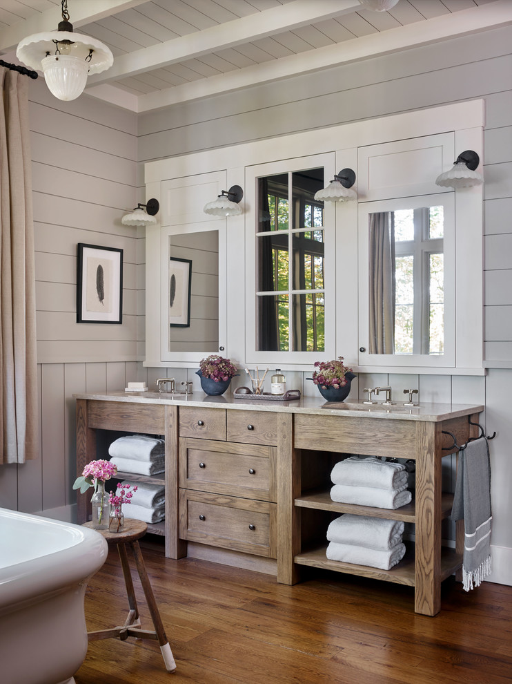 Rustic bathroom with medium wood cabinets, grey walls, medium hardwood flooring, a submerged sink, brown floors, grey worktops and shaker cabinets.