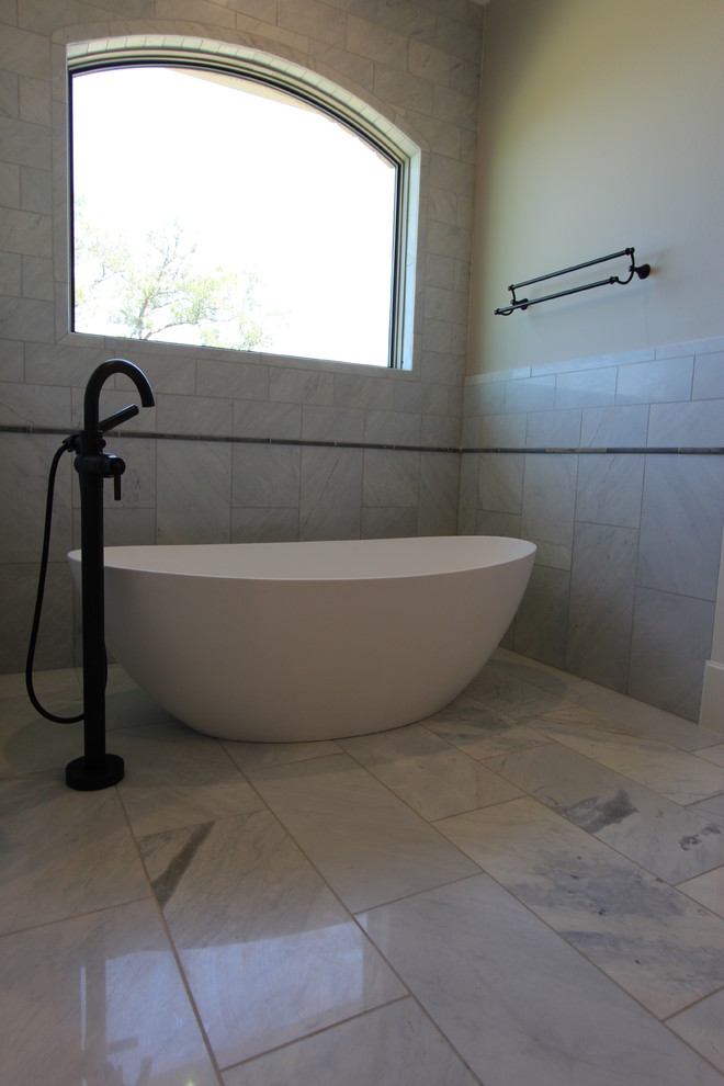 Design ideas for a large mediterranean ensuite bathroom in Austin with raised-panel cabinets, dark wood cabinets, a freestanding bath, a corner shower, a two-piece toilet, white tiles, marble tiles, beige walls, marble flooring, a vessel sink, marble worktops, white floors and a hinged door.