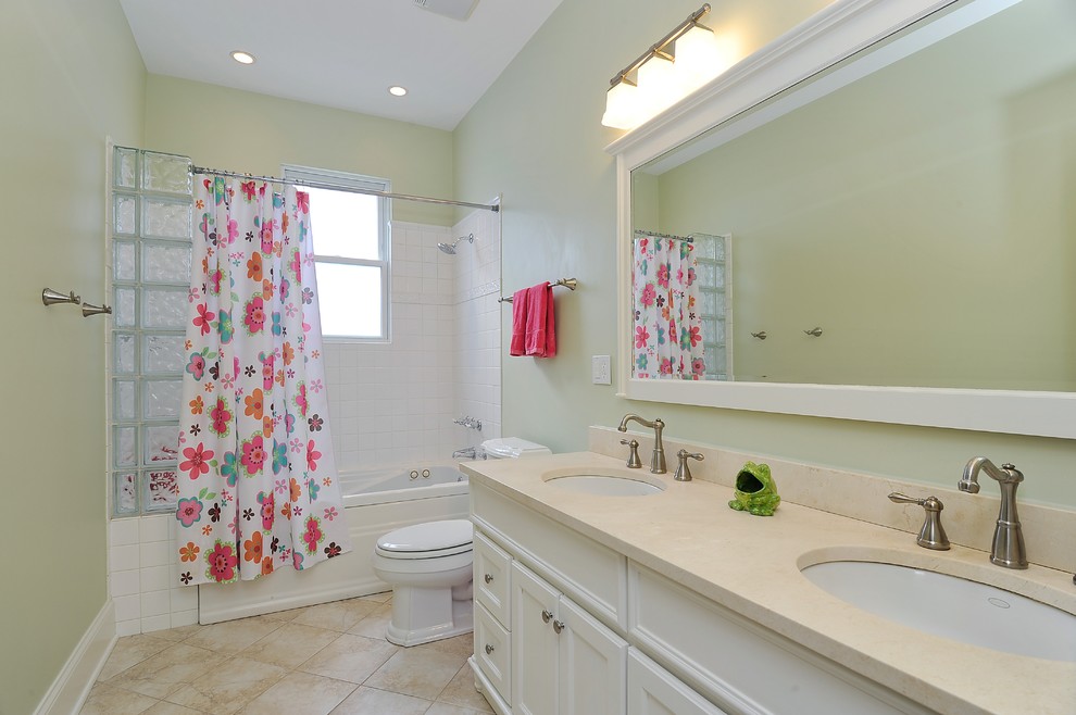 This is an example of a large classic family bathroom in Chicago with a submerged sink, raised-panel cabinets, white cabinets, granite worktops, an alcove bath, a shower/bath combination, a two-piece toilet, yellow tiles, ceramic tiles, green walls and ceramic flooring.