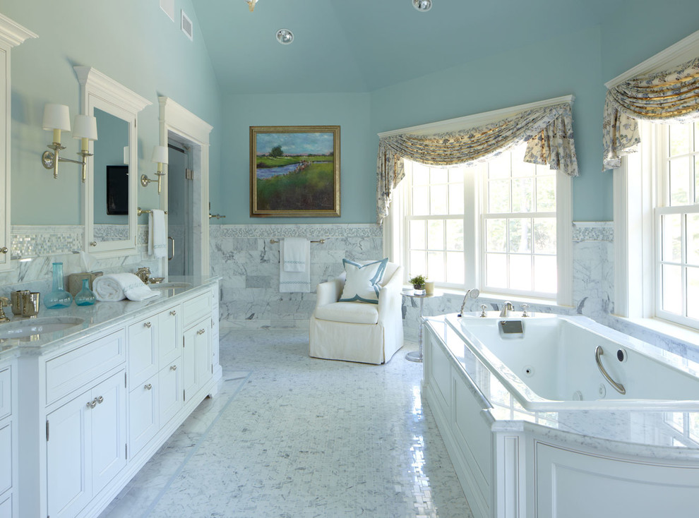 Inspiration for a large classic ensuite bathroom in New York with a submerged sink, white cabinets, a built-in bath, white tiles, marble worktops, blue walls, an alcove shower, a two-piece toilet, stone tiles, marble flooring, grey worktops and beaded cabinets.
