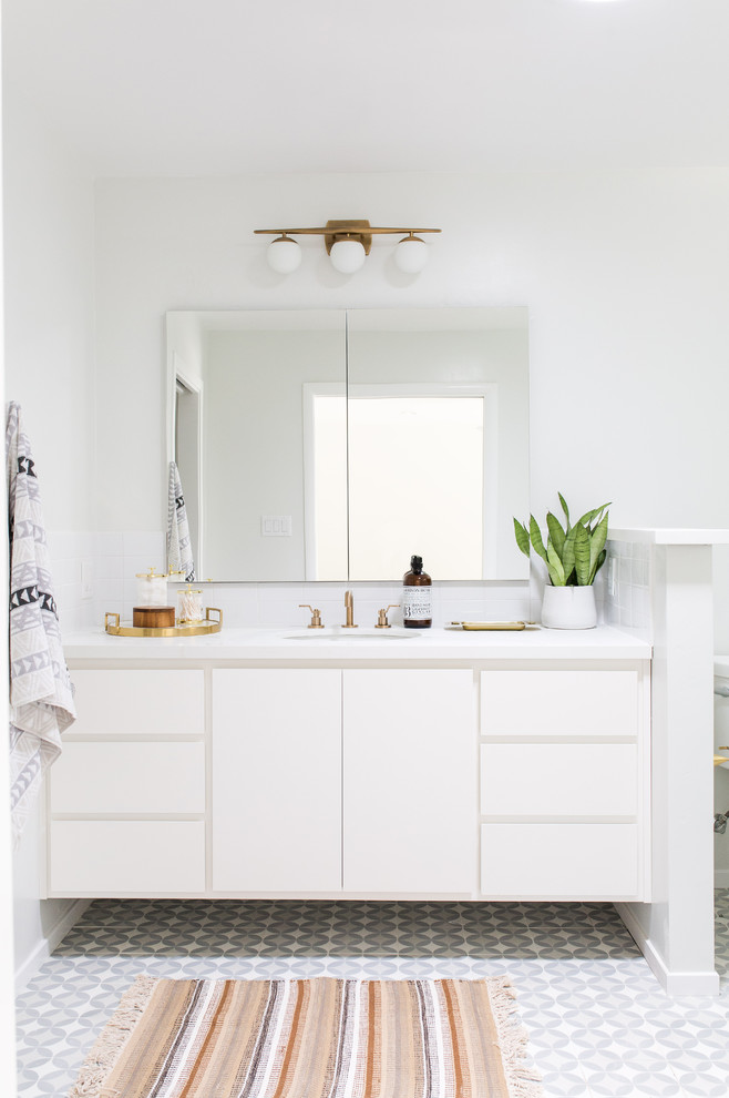 Inspiration for a contemporary gray floor bathroom remodel in Sacramento with flat-panel cabinets, white cabinets, white walls and an undermount sink