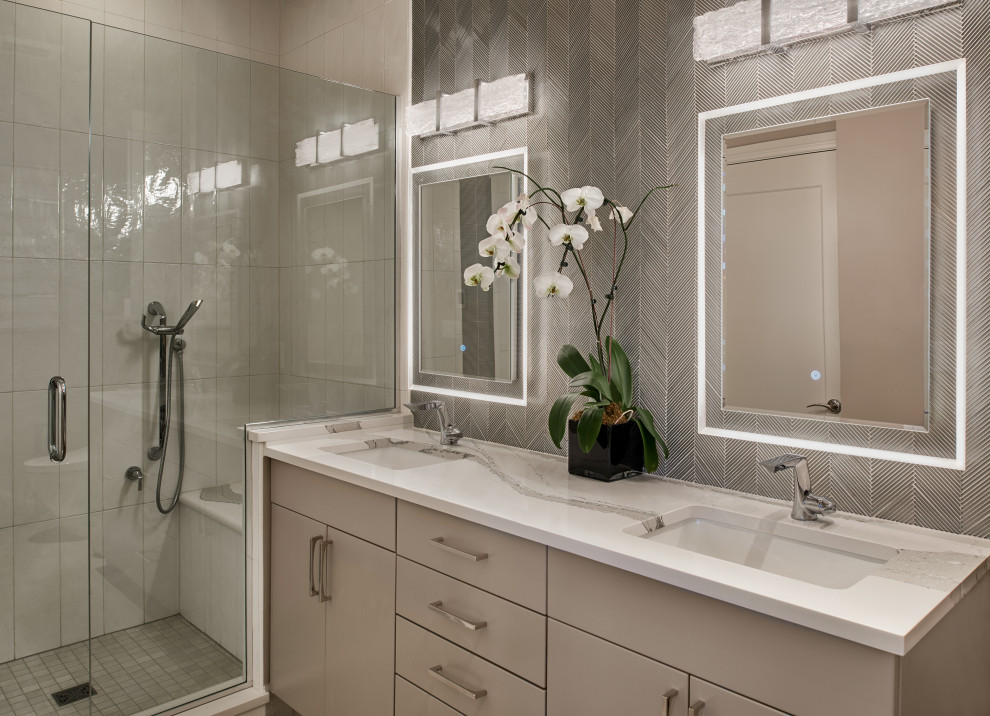 Example of a mid-sized minimalist master gray tile and ceramic tile porcelain tile, gray floor and double-sink bathroom design in Denver with flat-panel cabinets, gray cabinets, a bidet, gray walls, an undermount sink, quartz countertops, a hinged shower door, white countertops and a built-in vanity