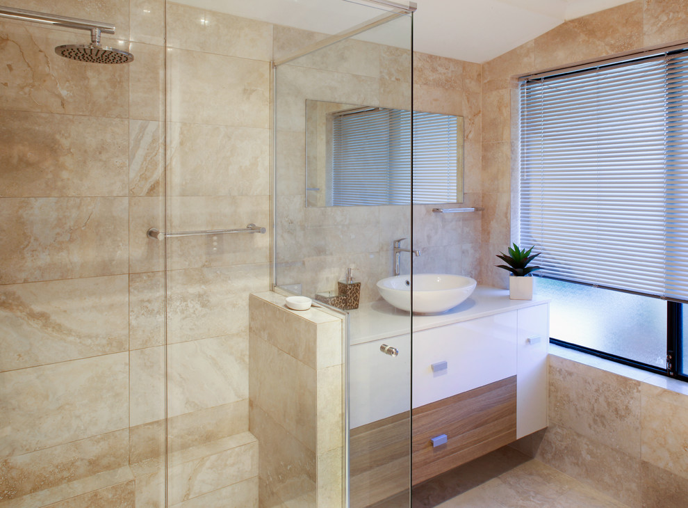 Photo of a small contemporary bathroom in Perth with a vessel sink, flat-panel cabinets, medium wood cabinets, engineered stone worktops, a claw-foot bath, a corner shower, beige tiles, stone slabs and porcelain flooring.