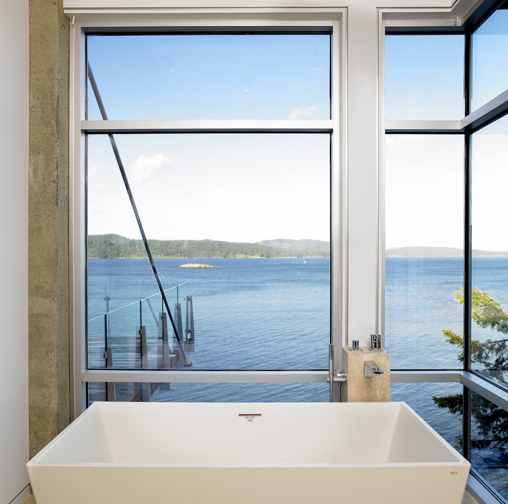 This is an example of a beach style bathroom in Vancouver with a freestanding bath.