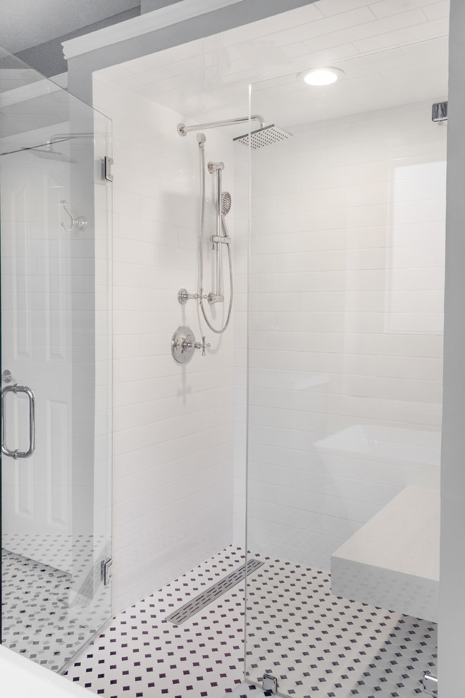 Example of a mid-sized transitional master white tile and ceramic tile ceramic tile and white floor bathroom design in Houston with shaker cabinets, gray cabinets, a one-piece toilet, gray walls, an undermount sink, quartz countertops, a hinged shower door and white countertops