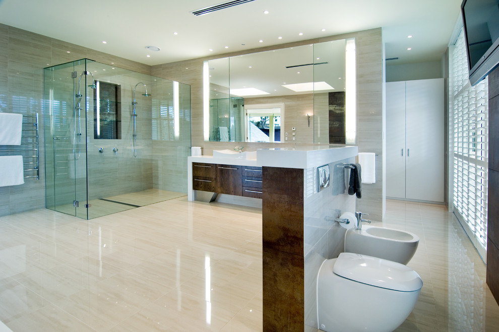 This is an example of a contemporary half tiled bathroom in Melbourne with a vessel sink, flat-panel cabinets, dark wood cabinets, an alcove shower, a bidet and beige tiles.