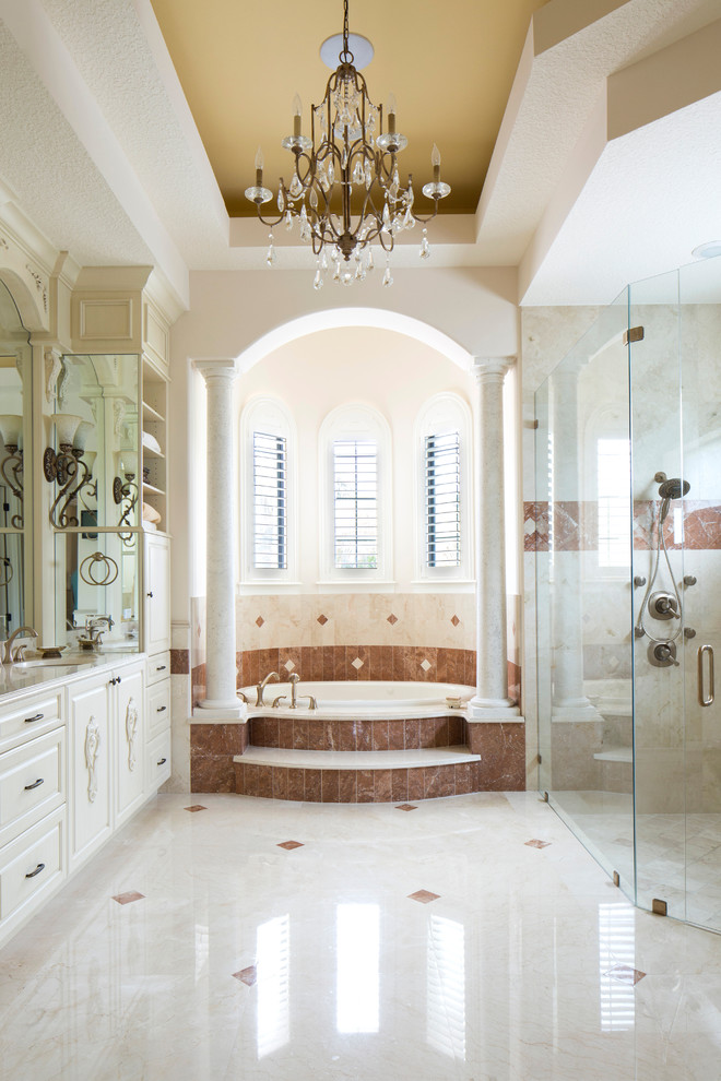 Inspiration for a mediterranean master marble floor bathroom remodel in Orlando with a drop-in sink and a hot tub