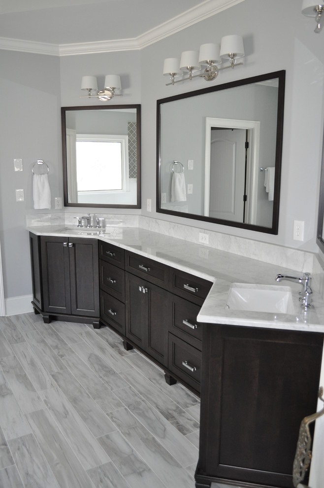 Design ideas for a large classic ensuite bathroom in Atlanta with shaker cabinets, dark wood cabinets, a built-in bath, a corner shower, grey tiles, porcelain tiles, grey walls, porcelain flooring, a submerged sink and marble worktops.