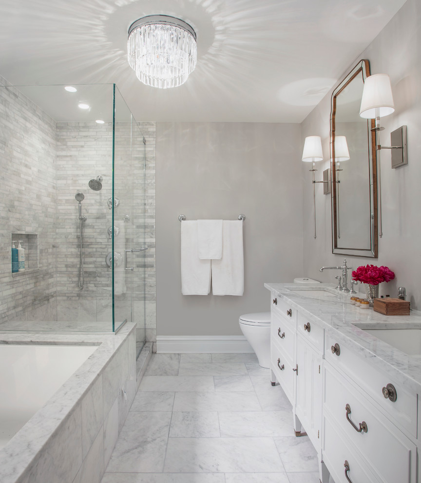 Example of a mid-sized transitional master gray tile and stone tile marble floor and gray floor corner shower design in Chicago with an undermount sink, furniture-like cabinets, gray cabinets, marble countertops, an undermount tub, a two-piece toilet, gray walls and a hinged shower door