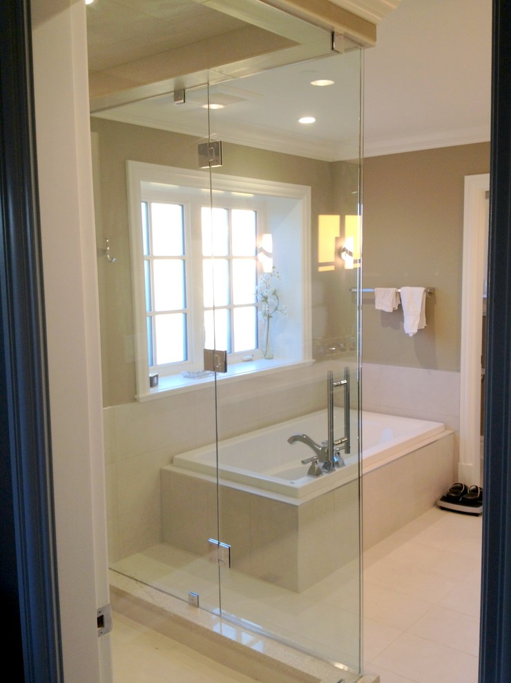 This is an example of a large contemporary ensuite bathroom in Vancouver with a built-in bath, porcelain tiles, brown walls and porcelain flooring.