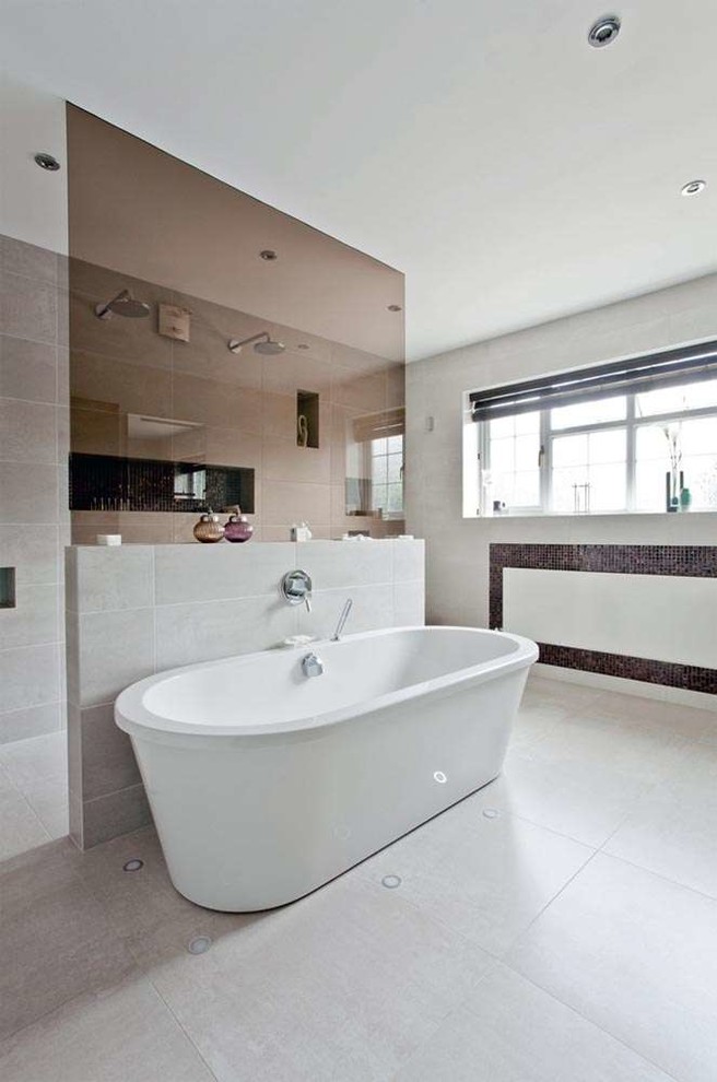 Example of a huge trendy master gray tile and porcelain tile porcelain tile bathroom design in Oxfordshire with an integrated sink, flat-panel cabinets, dark wood cabinets, a wall-mount toilet and gray walls