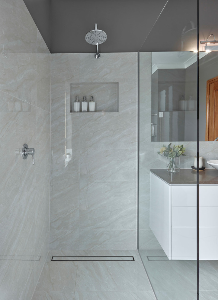 Photo of a medium sized contemporary ensuite bathroom in Other with flat-panel cabinets, white cabinets, a freestanding bath, a walk-in shower, beige tiles, porcelain tiles, grey walls, porcelain flooring, a pedestal sink, engineered stone worktops, beige floors, an open shower and brown worktops.