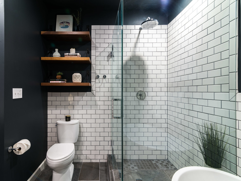 Design ideas for a medium sized modern ensuite bathroom in DC Metro with shaker cabinets, dark wood cabinets, a freestanding bath, a corner shower, metro tiles, grey walls, a submerged sink, solid surface worktops, grey floors, a hinged door, white worktops, a two-piece toilet, white tiles and limestone flooring.