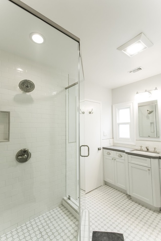 Photo of an expansive modern shower room bathroom in Los Angeles with a built-in sink, shaker cabinets, white cabinets, granite worktops, a freestanding bath, a corner shower, a one-piece toilet, white tiles, metro tiles, white walls and porcelain flooring.