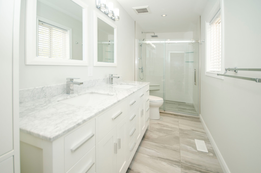 Design ideas for a medium sized classic shower room bathroom in Toronto with beaded cabinets, white cabinets, an alcove shower, a two-piece toilet, white tiles, porcelain tiles, grey walls, porcelain flooring, a submerged sink, quartz worktops, beige floors and a sliding door.