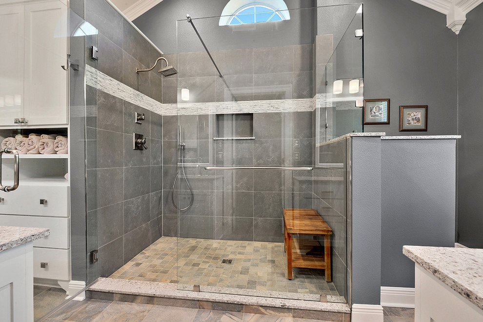 Photo of a medium sized classic ensuite bathroom in New Orleans with a submerged sink, shaker cabinets, white cabinets, engineered stone worktops, an alcove shower, a two-piece toilet, grey tiles, porcelain tiles, grey walls and porcelain flooring.