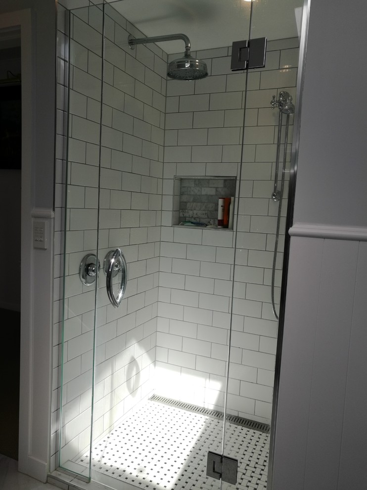 Example of a large trendy white tile and porcelain tile mosaic tile floor and multicolored floor corner shower design in Wellington with white walls and a hinged shower door