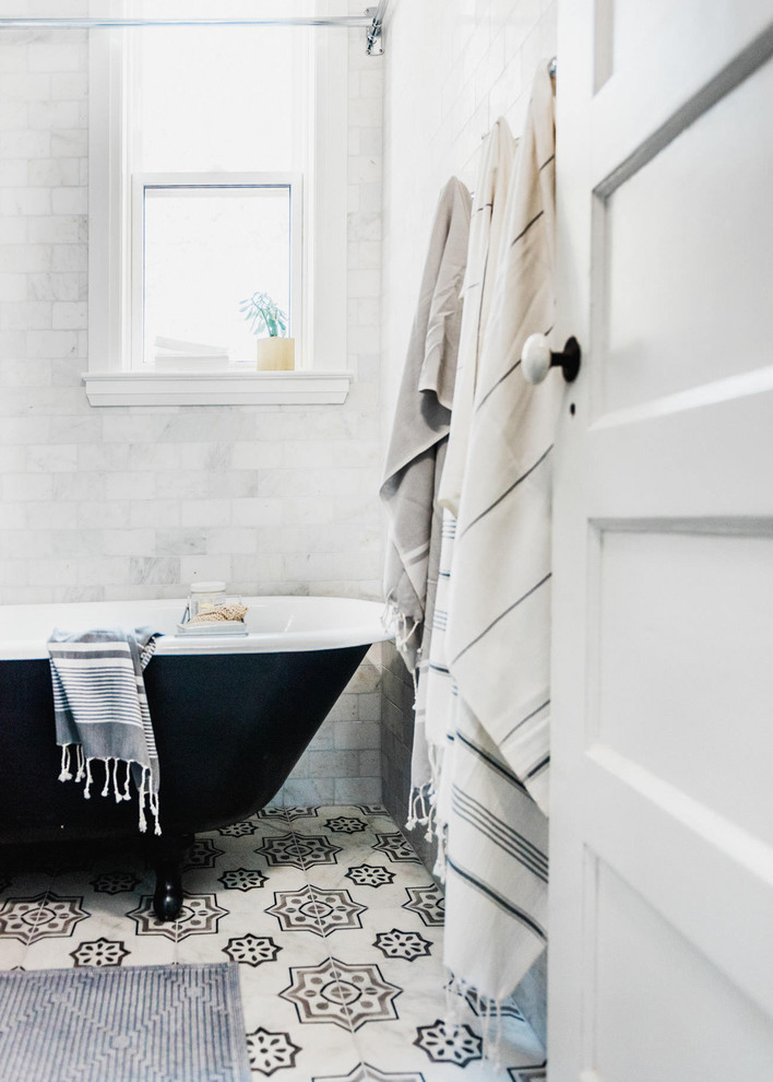 Design ideas for a vintage ensuite bathroom in Toronto with a claw-foot bath, a shower/bath combination, white tiles, marble tiles, marble flooring and a console sink.