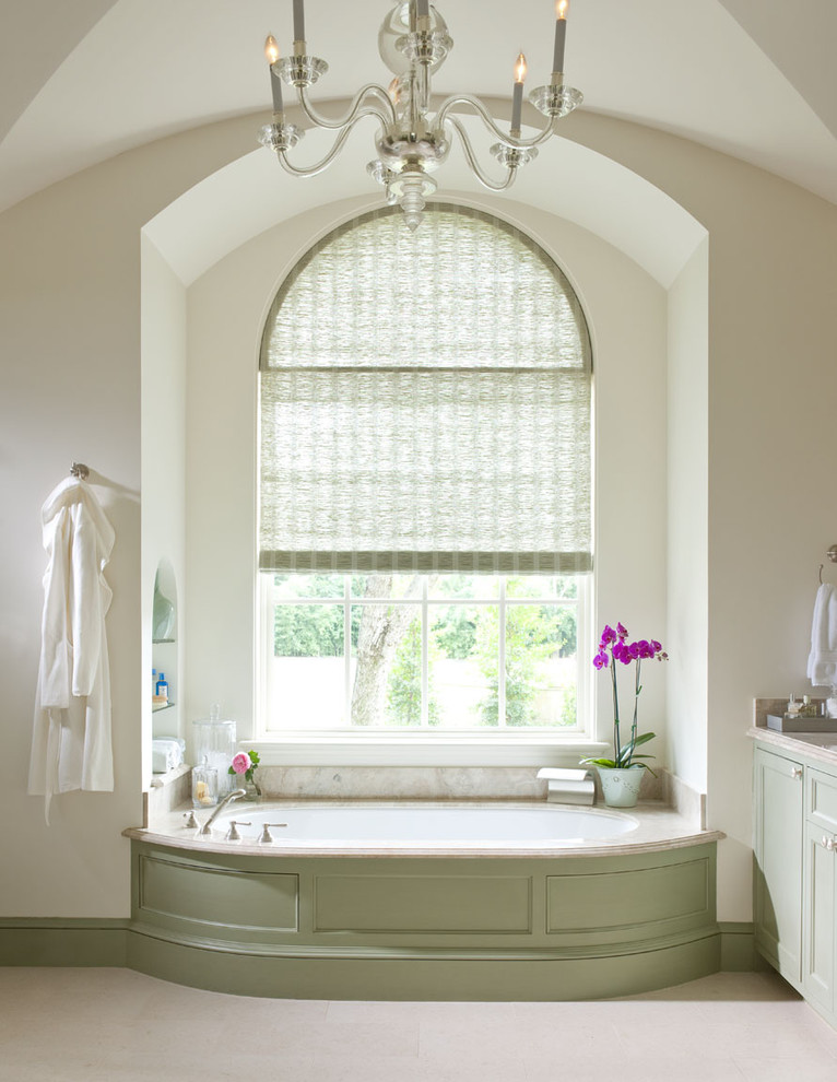 Alcove bathtub - traditional beige tile alcove bathtub idea in Dallas with recessed-panel cabinets and green cabinets