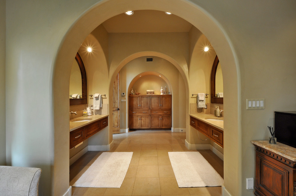 Idée de décoration pour une salle de bain design en bois brun avec un lavabo encastré et un placard avec porte à panneau encastré.