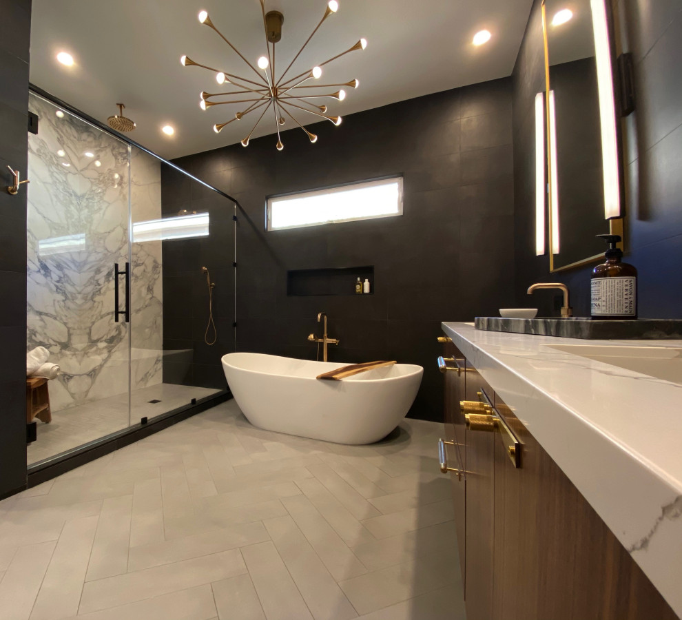 Example of a large trendy master black tile and porcelain tile porcelain tile and gray floor freestanding bathtub design in San Diego with flat-panel cabinets, medium tone wood cabinets, a one-piece toilet, black walls, an undermount sink, quartz countertops and white countertops