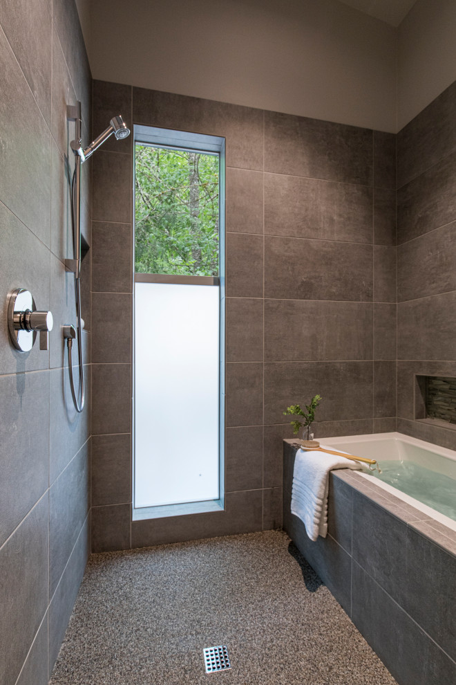 Photo of a small contemporary wet room bathroom in Portland with a built-in bath, grey walls, grey floors and a hinged door.