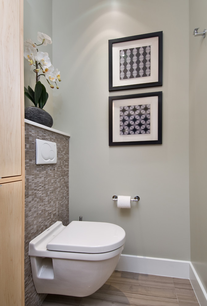 Modern cloakroom in Ottawa with a vessel sink, flat-panel cabinets, light wood cabinets, engineered stone worktops, a wall mounted toilet, beige tiles, stone slabs, beige walls and limestone flooring.