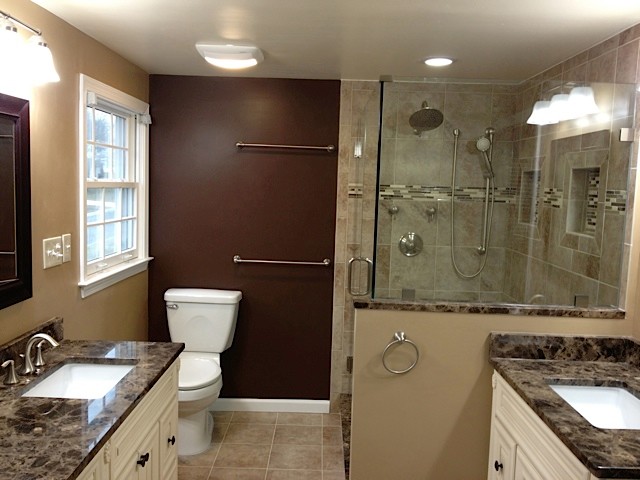 Medium sized traditional ensuite bathroom in DC Metro with raised-panel cabinets, white cabinets, an alcove shower, a two-piece toilet, beige tiles, matchstick tiles, beige walls, ceramic flooring, a submerged sink, marble worktops, brown floors and a hinged door.