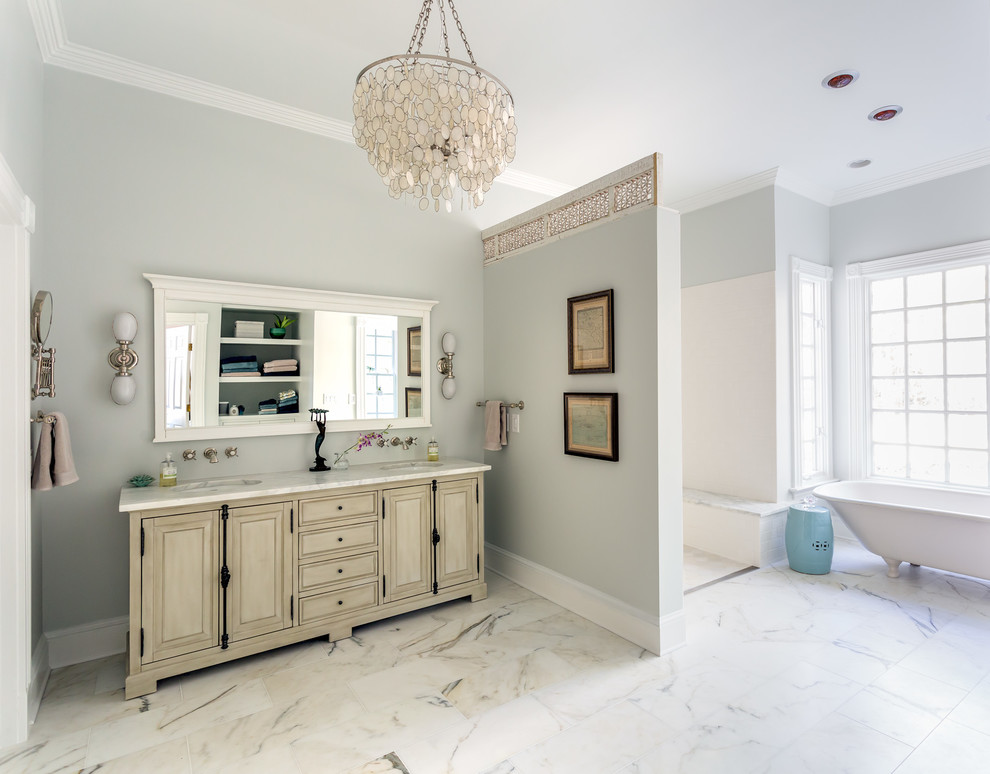 Large classic ensuite bathroom in Raleigh with distressed cabinets, a claw-foot bath, a built-in shower, a two-piece toilet, white tiles, stone slabs, grey walls, marble flooring, a submerged sink, marble worktops, raised-panel cabinets, white floors, an open shower and white worktops.