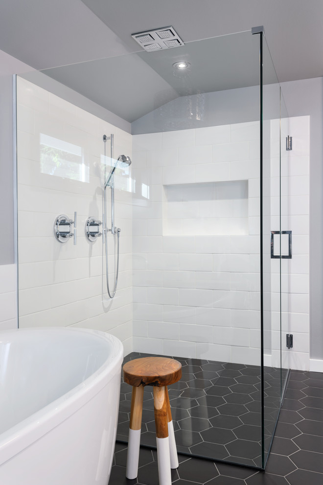 Design ideas for a medium sized classic ensuite bathroom in Seattle with shaker cabinets, white cabinets, a freestanding bath, a built-in shower, a two-piece toilet, white tiles, ceramic tiles, grey walls, porcelain flooring, a submerged sink, engineered stone worktops, black floors, a hinged door and white worktops.