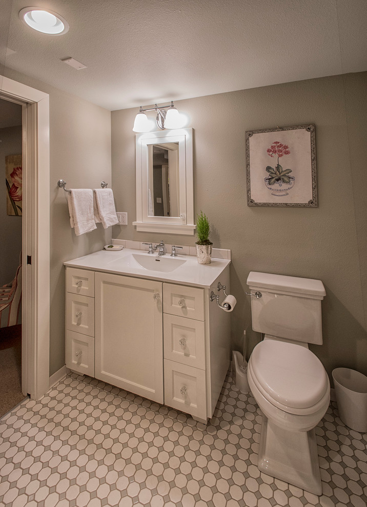 Inredning av ett klassiskt litet badrum, med ett integrerad handfat, skåp i shakerstil, grå skåp, en toalettstol med separat cisternkåpa, flerfärgad kakel och beige väggar