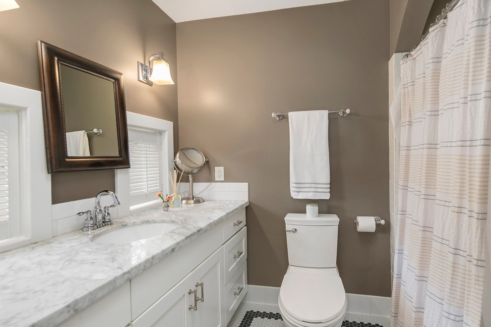 Mid-sized elegant master white tile and subway tile ceramic tile and white floor bathroom photo in Seattle with shaker cabinets, white cabinets, a two-piece toilet, brown walls, an undermount sink, marble countertops and white countertops