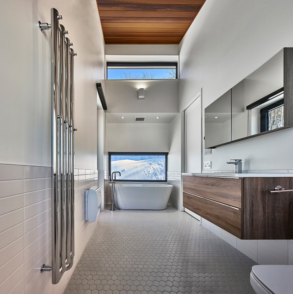 Design ideas for a large modern shower room bathroom in Montreal with flat-panel cabinets, medium wood cabinets, a freestanding bath, a two-piece toilet, white walls, mosaic tile flooring, a submerged sink, quartz worktops, grey floors, an alcove shower, an open shower, white tiles and metro tiles.