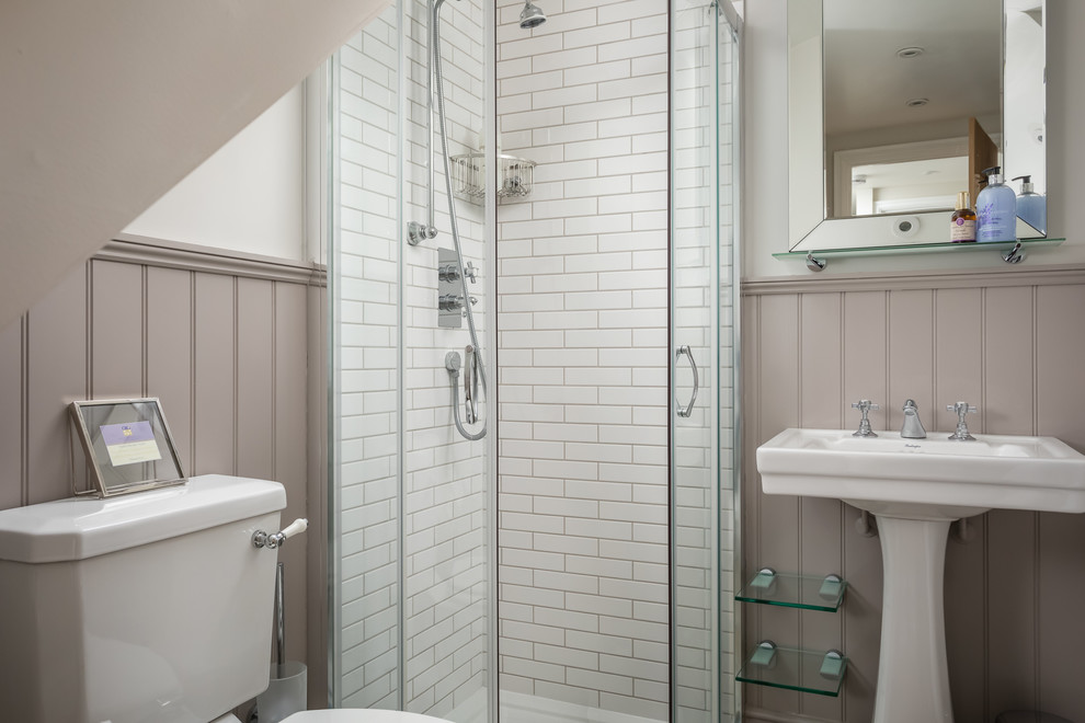 Inspiration for a small country ensuite bathroom in Gloucestershire with a corner shower, a one-piece toilet, white tiles, a console sink and a sliding door.