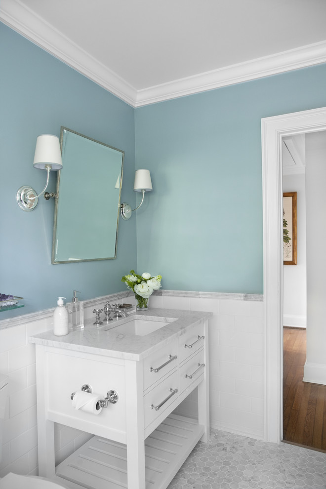 This is an example of a traditional half tiled bathroom in Atlanta with metro tiles, a console sink and a dado rail.