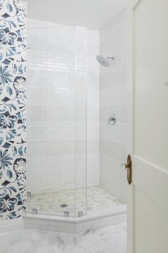 Inspiration for a family bathroom in New York with an alcove shower, white tiles, porcelain tiles, marble flooring, a hinged door, wallpapered walls and white floors.