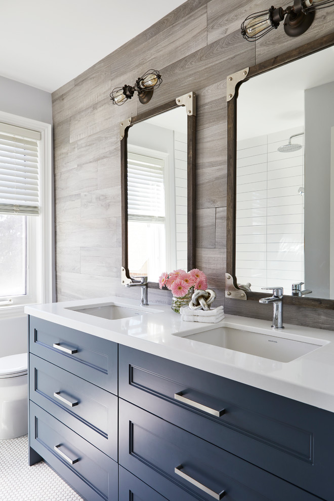 Example of a transitional gray tile mosaic tile floor and white floor bathroom design in Toronto with recessed-panel cabinets, blue cabinets, gray walls, an undermount sink and white countertops
