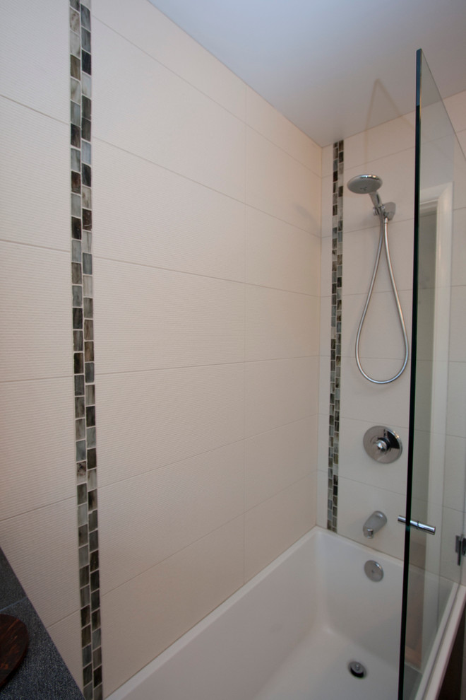 Medium sized modern ensuite bathroom in Portland with flat-panel cabinets, dark wood cabinets, a built-in bath, a corner shower, a two-piece toilet, white tiles, ceramic tiles, grey walls, concrete flooring, a vessel sink, granite worktops, brown floors and a hinged door.